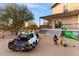 Quirky backyard features a wrecked car and dinosaur statue at 30017 N 60Th St, Cave Creek, AZ 85331