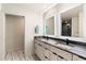 Double vanity bathroom with a large mirror and grey tile at 30017 N 60Th St, Cave Creek, AZ 85331