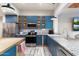 Modern kitchen with blue cabinets, granite countertops, and stainless steel appliances at 30017 N 60Th St, Cave Creek, AZ 85331