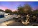 Landscaped backyard with mature trees and unique wagon decor at 30017 N 60Th St, Cave Creek, AZ 85331