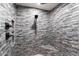 Large walk in shower with grey brick tile and corner seat at 30017 N 60Th St, Cave Creek, AZ 85331