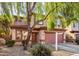 Two-story house with a two-car garage and mature trees in front at 3613 W Kathleen Rd, Phoenix, AZ 85053