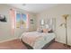 Cozy bedroom with a plush bed, floor lamp, and window with blinds at 4642 W Alabama Ln, San Tan Valley, AZ 85144