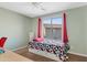 Bedroom with twin bed, large window, and ceiling fan at 4642 W Alabama Ln, San Tan Valley, AZ 85144