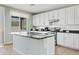 Spacious kitchen with island, stainless steel appliances, and white cabinets at 4642 W Alabama Ln, San Tan Valley, AZ 85144