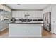 Kitchen with white cabinets, granite island, and stainless steel appliances at 4642 W Alabama Ln, San Tan Valley, AZ 85144