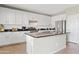 Bright kitchen boasts white cabinets, granite countertops, and an island at 4642 W Alabama Ln, San Tan Valley, AZ 85144