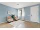 Living room with two armchairs, a plant, and a door leading outside at 4642 W Alabama Ln, San Tan Valley, AZ 85144
