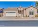 Tan house with a white garage door and desert landscaping at 4918 E Michigan Ave, Scottsdale, AZ 85254