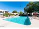 Community pool with lounge chairs and red umbrellas at 7663 E Pleasant Run, Scottsdale, AZ 85258