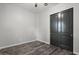 Bedroom with dark gray double doors and wood-look floors at 9822 E Thornbush Ave, Mesa, AZ 85212