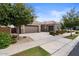 Two-car garage home with landscaping and driveway at 9822 E Thornbush Ave, Mesa, AZ 85212