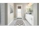 Spa-like bathroom with double vanities, a large mirror, and an exterior door at 1 N Brenner Pass Rd, Queen Creek, AZ 85144