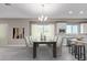 Bright dining room featuring a large table with six chairs and an open view to the kitchen at 1 N Brenner Pass Rd, Queen Creek, AZ 85144