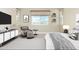 Main bedroom with a large bed, a comfortable chair and ottoman, and plenty of natural light at 1 N Brenner Pass Rd, Queen Creek, AZ 85144