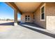 Covered patio extends from the back of the house with a view of the desert landscape at 1 N Brenner Pass Rd, Queen Creek, AZ 85144