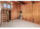 Bedroom with wood walls, carpet, and loft access at 16409 E Kingstree Blvd, Fountain Hills, AZ 85268