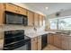 View of kitchen with granite countertops and stovetop at 18804 N 95Th Ave, Peoria, AZ 85382