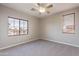 Bright bedroom with carpet flooring, large window, and ceiling fan at 1923 E Zion Way, Chandler, AZ 85249