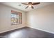 Bedroom with dark wood floors and a large window at 1923 E Zion Way, Chandler, AZ 85249