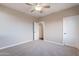Carpeted bedroom with ceiling fan and additional door at 1923 E Zion Way, Chandler, AZ 85249