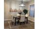 Elegant dining room with modern lighting, neutral decor, and window at 1923 E Zion Way, Chandler, AZ 85249