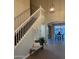 Bright entryway featuring high ceilings, staircase with white railing, and tile flooring at 1923 E Zion Way, Chandler, AZ 85249