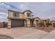 Two-story house with a brown garage door and landscaping at 1923 E Zion Way, Chandler, AZ 85249