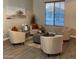 Cozy living area with stylish chairs, ottoman, modern artwork, and natural light at 1923 E Zion Way, Chandler, AZ 85249