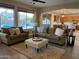 Inviting living room featuring plush sofas, an ottoman coffee table, and a view of the pool at 1923 E Zion Way, Chandler, AZ 85249