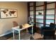 Well-lit office space with built-in bookshelves and a modern desk, perfect for a home workspace at 1923 E Zion Way, Chandler, AZ 85249