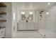 Bathroom featuring double sink vanity, marble floors, and shower with glass door at 2265 E Elmwood St, Mesa, AZ 85213