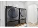 Modern laundry room with front-loading washer and dryer set on light wood countertop at 2265 E Elmwood St, Mesa, AZ 85213