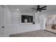 Bright living room with built-in shelving, storage, and a ceiling fan for added comfort at 2265 E Elmwood St, Mesa, AZ 85213