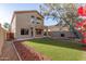 House with backyard featuring artificial turf and a grilling area at 30417 N 42Nd Pl, Cave Creek, AZ 85331