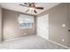 Spacious bedroom with ceiling fan and sliding closet doors at 30417 N 42Nd Pl, Cave Creek, AZ 85331