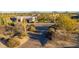 Aerial view of a luxury home with a long driveway and desert landscaping at 35931 N 82Nd Pl, Scottsdale, AZ 85266