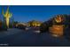 Night view of luxury home entrance with brick columns and lighting at 35931 N 82Nd Pl, Scottsdale, AZ 85266