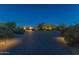 Night view of luxury home with driveway and landscape lighting at 35931 N 82Nd Pl, Scottsdale, AZ 85266