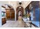 Elegant hallway with arched entryways and brick detailing leading to other rooms at 35931 N 82Nd Pl, Scottsdale, AZ 85266