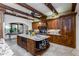 Gourmet kitchen with granite island, wood cabinetry, and stainless steel appliances at 35931 N 82Nd Pl, Scottsdale, AZ 85266
