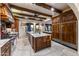 Spacious kitchen featuring wood cabinetry, granite countertops, and high-end appliances at 35931 N 82Nd Pl, Scottsdale, AZ 85266