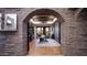Bright home office seen through an arched entryway, offering a functional workspace at 35931 N 82Nd Pl, Scottsdale, AZ 85266
