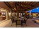 Covered patio with dining table, comfortable seating, and pool views at 35931 N 82Nd Pl, Scottsdale, AZ 85266