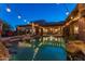 Stunning pool and patio at dusk, with string lights and mountain views at 35931 N 82Nd Pl, Scottsdale, AZ 85266