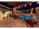 Relaxing pool area with patio furniture and string lights at 35931 N 82Nd Pl, Scottsdale, AZ 85266