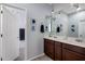 Double vanity bathroom with dark brown cabinets and a large mirror at 3655 E Louise Dr, Phoenix, AZ 85050