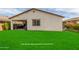 Covered patio, grassy yard, and small built-in grill at 3908 S 78Th Ln, Phoenix, AZ 85043