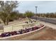 Tuscano community entrance sign with colorful flowers and desert landscaping at 3908 S 78Th Ln, Phoenix, AZ 85043