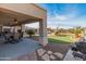 Covered patio overlooking a putting green and pool at 6614 S Cottonfields Ln, Laveen, AZ 85339